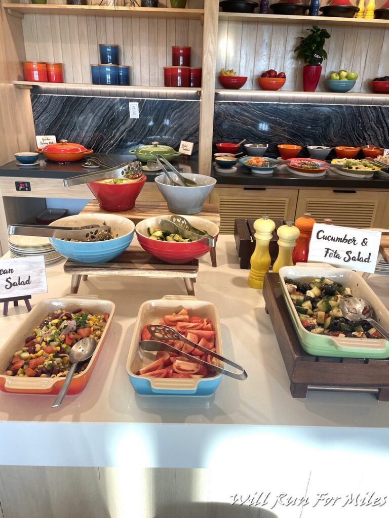 a buffet table with different bowls of food