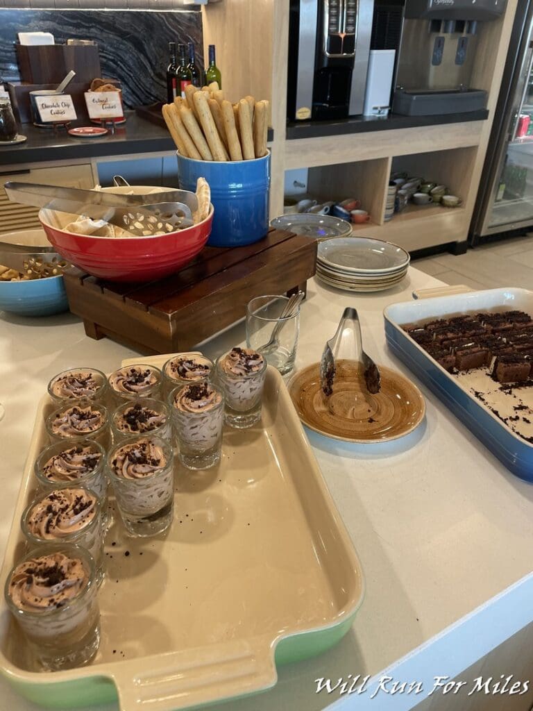 a table with desserts and bread sticks