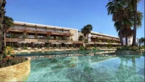 a pool with a building and palm trees
