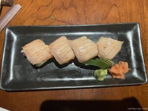 a plate of sushi on a wood table