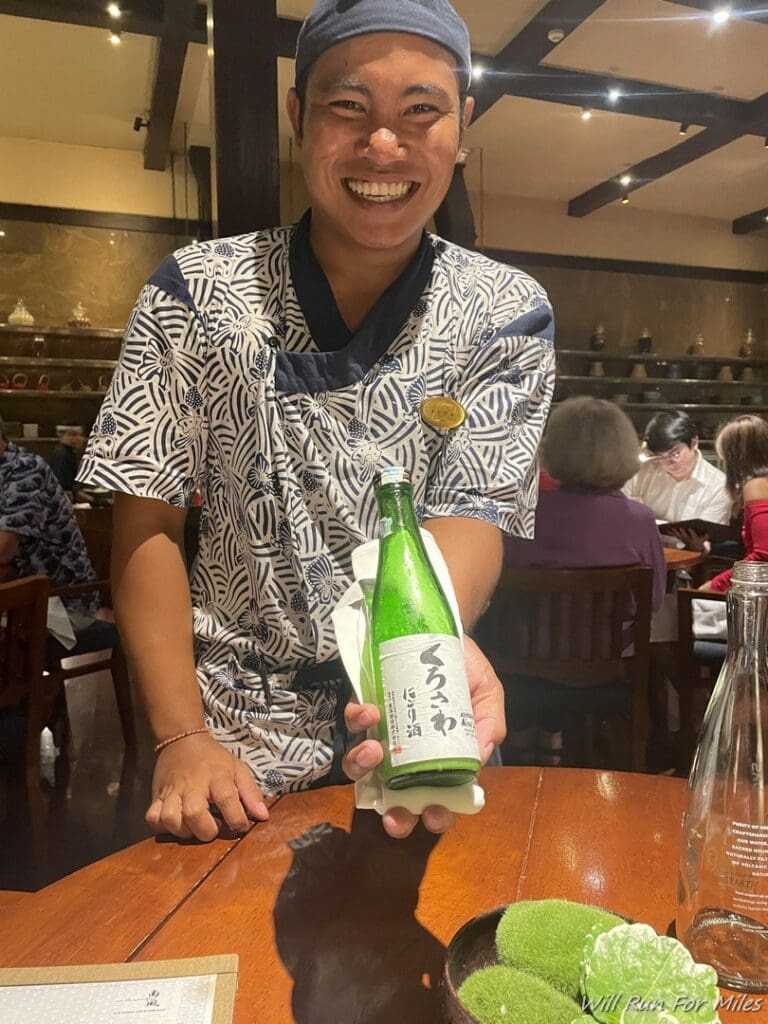 a man holding a bottle of beer