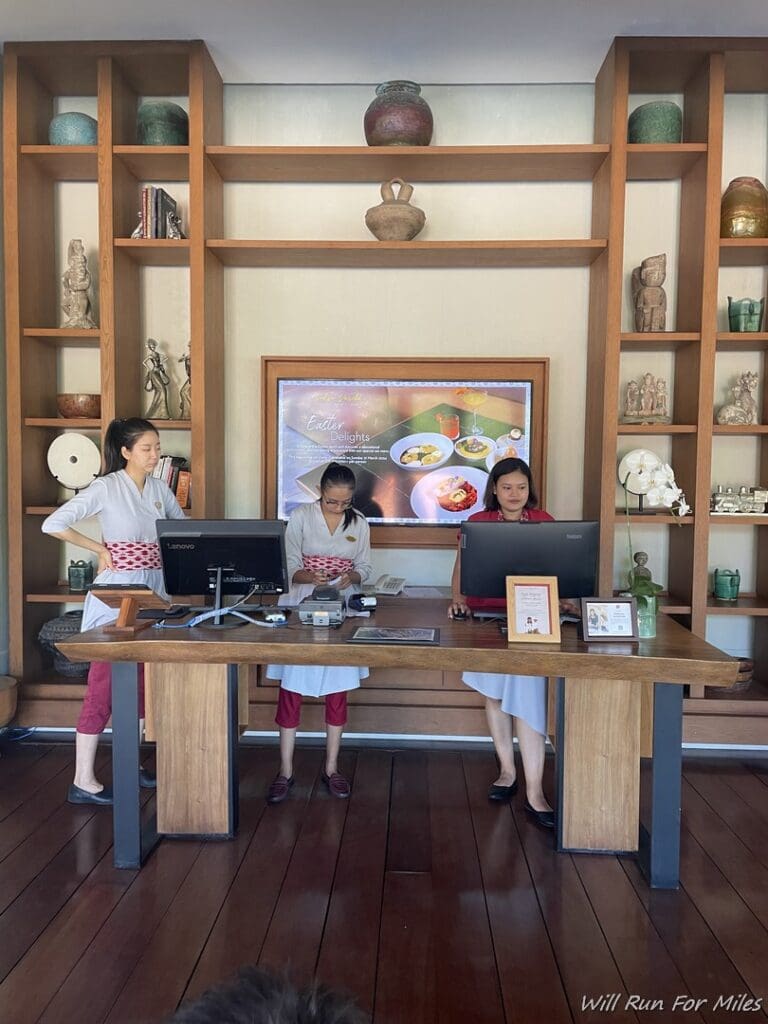 a group of women standing in front of a desk