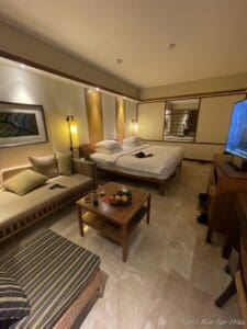 a room with two beds and a television