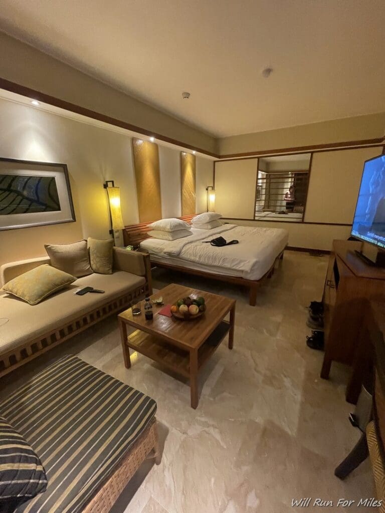 a room with two beds and a television