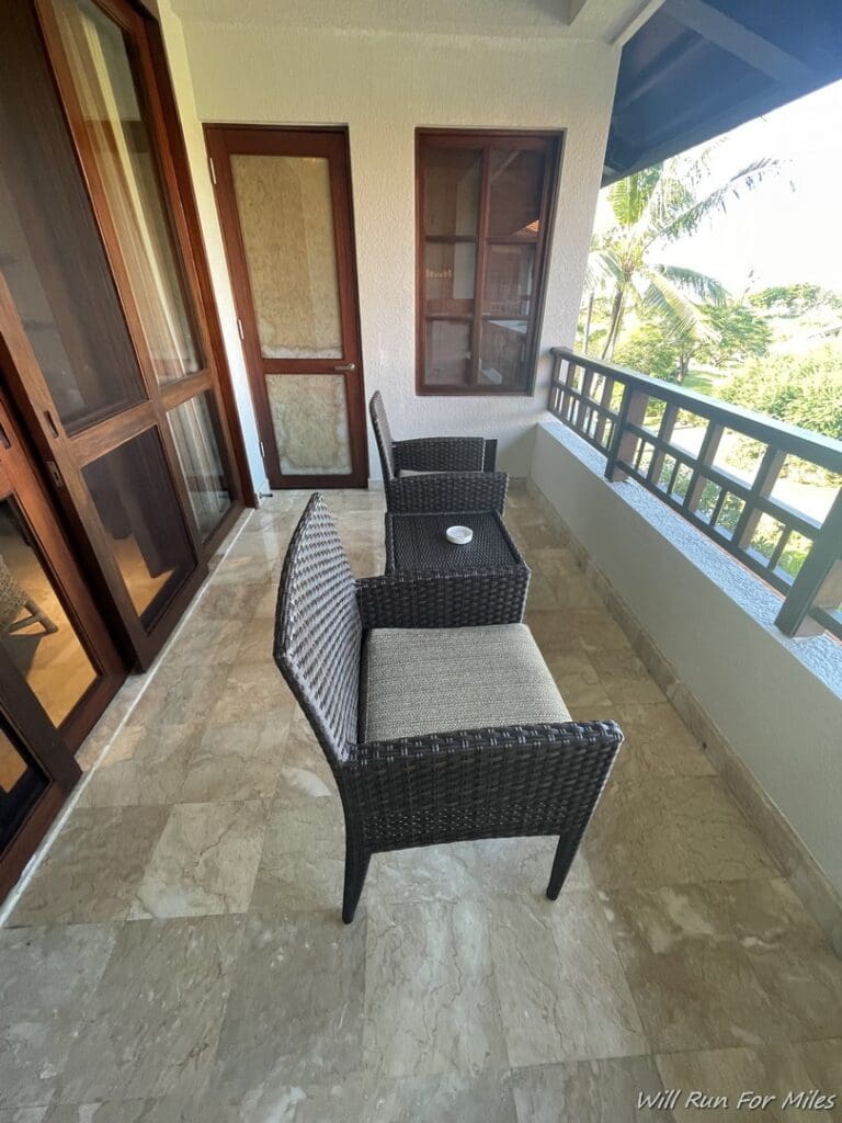 a patio with chairs and a table