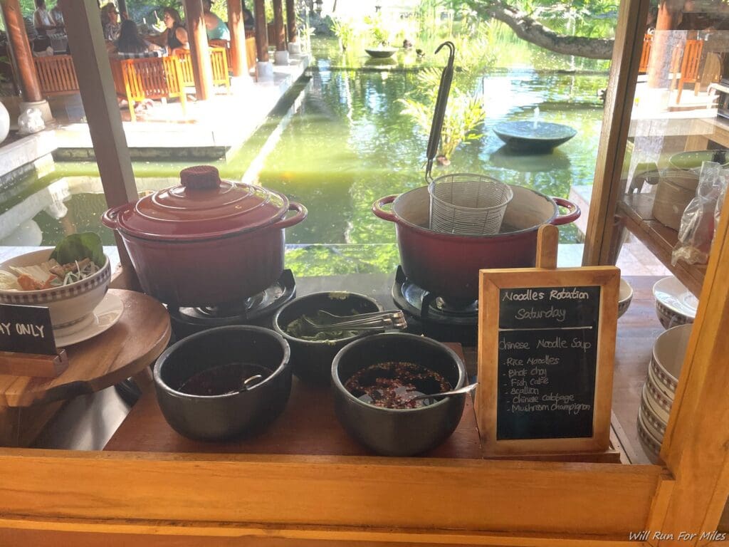 a table with bowls and bowls of food on it