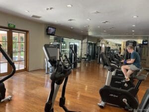 a man sitting on exercise bikes in a gym