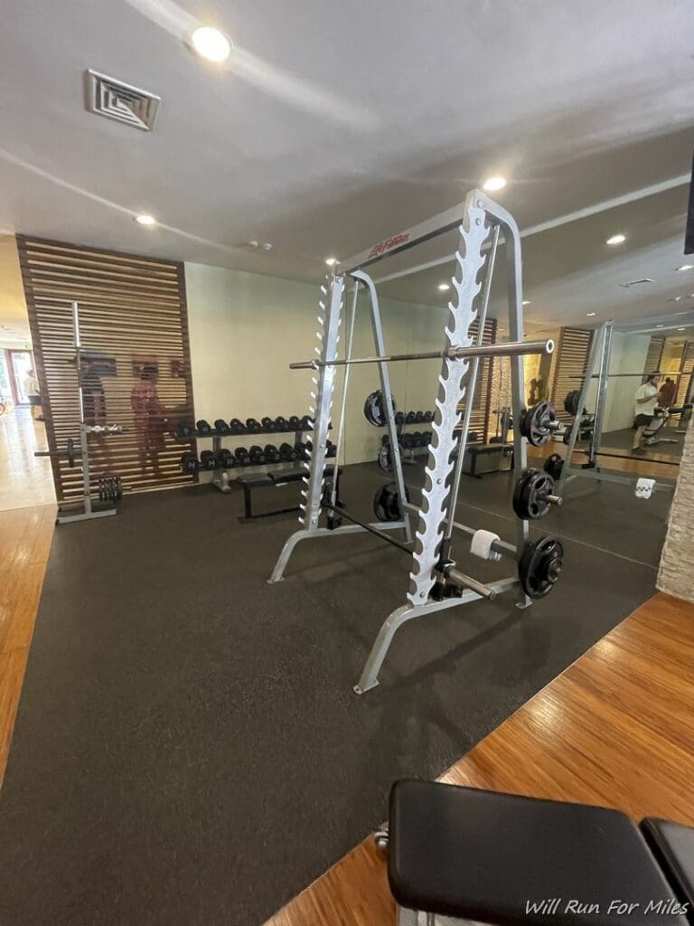 a gym with weights and a mirror