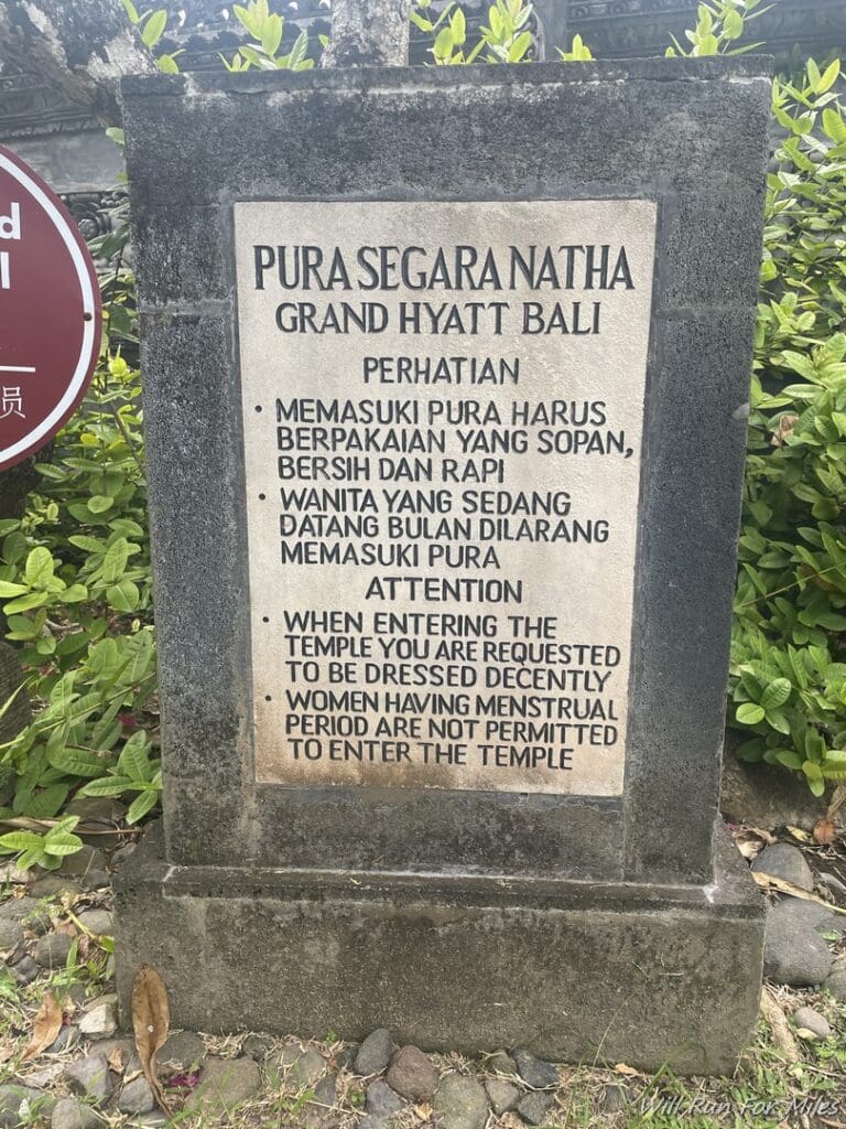 a stone sign with black text