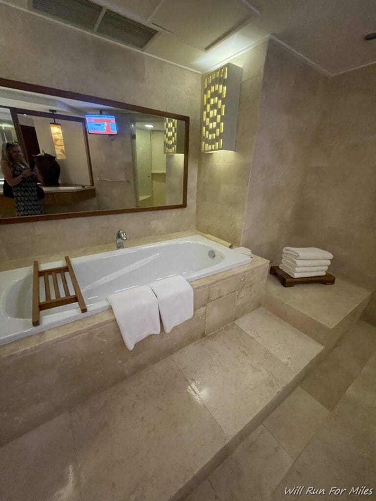 a bathroom with a bathtub and a mirror