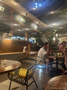a group of people sitting at tables in a restaurant