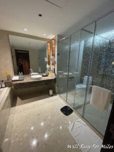 a bathroom with a glass shower and sink
