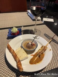a plate of food and a glass of wine