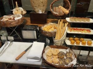 a table with different types of bread and pastries