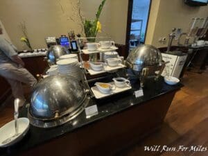 a buffet with a group of silver bowls and bowls