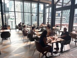 a group of people sitting at tables in a restaurant