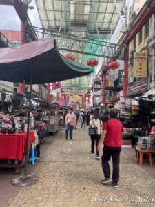 a street with people walking and umbrellas