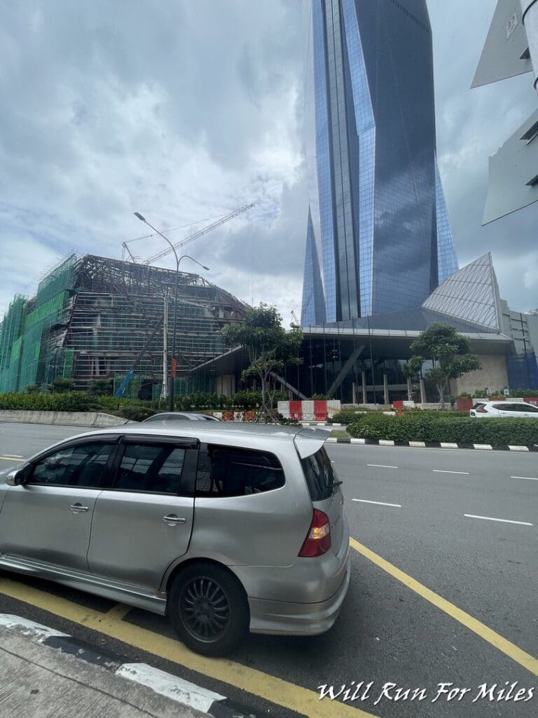 a car parked on a street next to a tall building