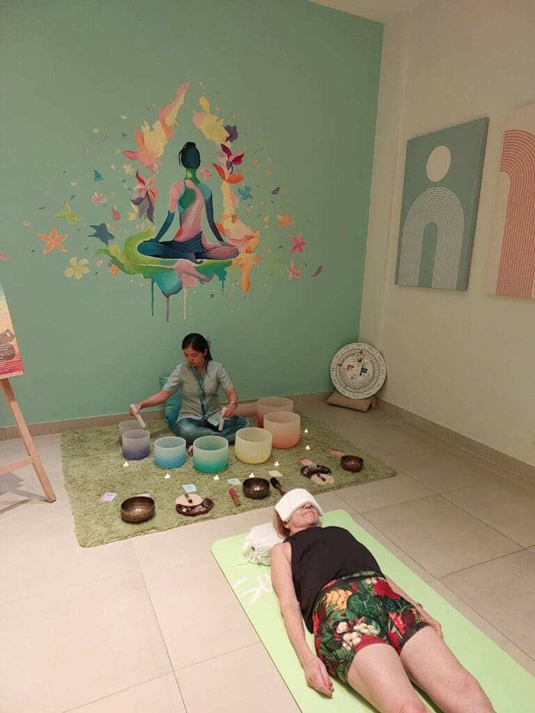 a woman sitting on a rug with bowls on it