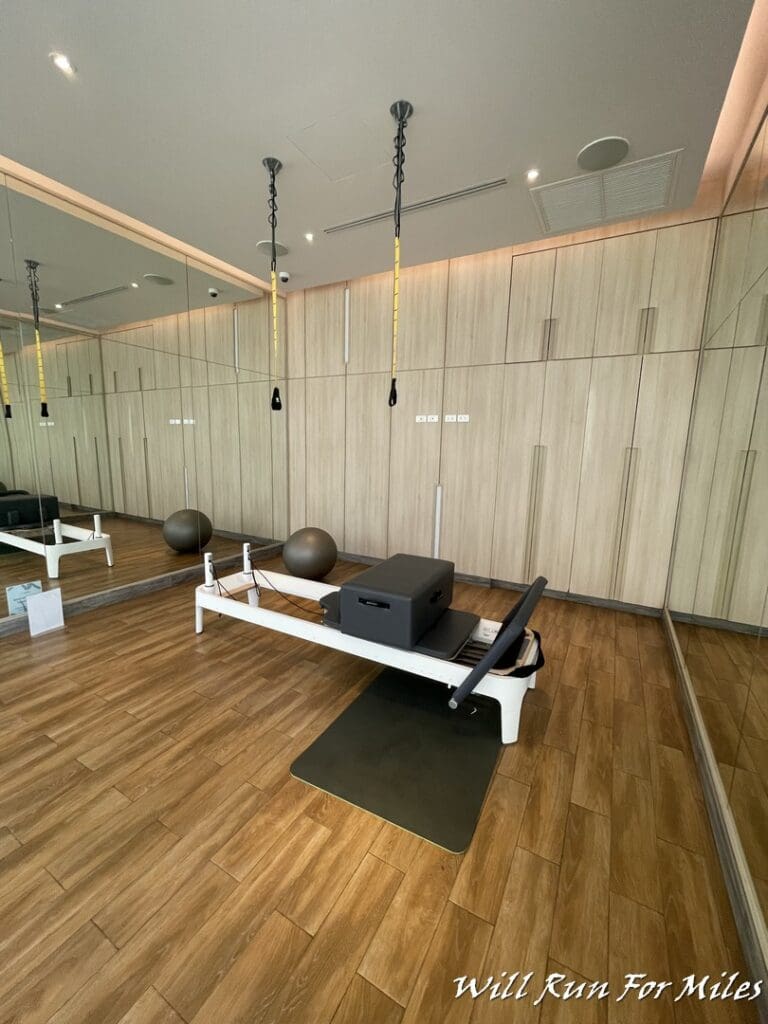 a room with a pilates machine and balls