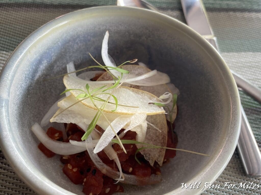 a bowl of food with onion and onion slices