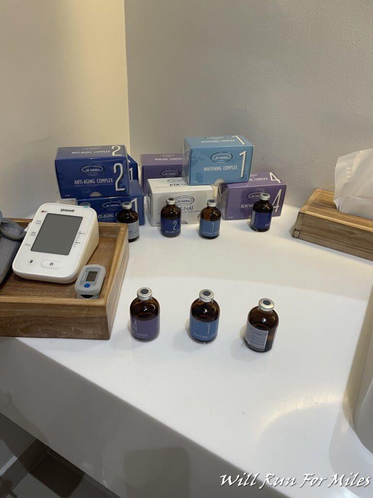 a table with a variety of medicine bottles and a device