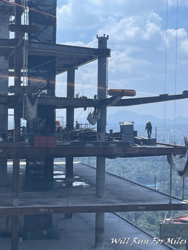 a construction site with workers on the side