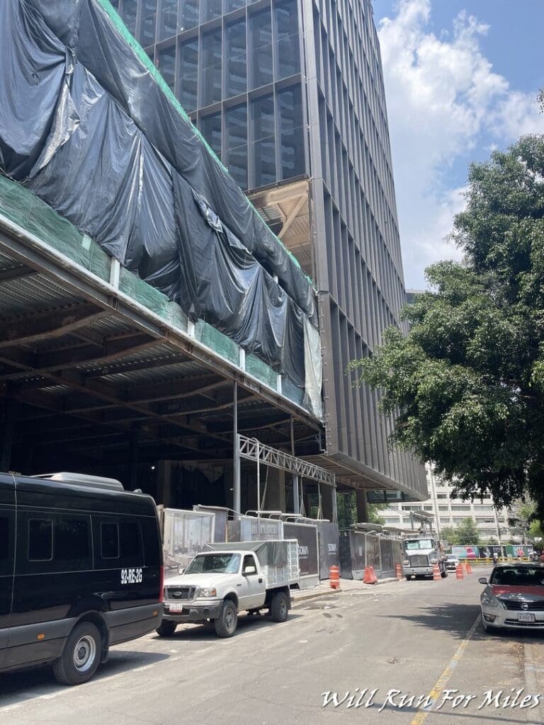 a building under construction with black tarp covering