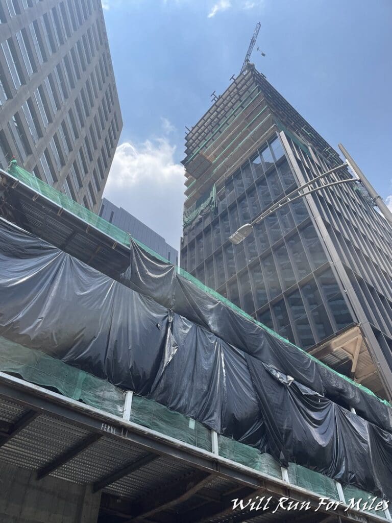 a building under construction with tarp covering