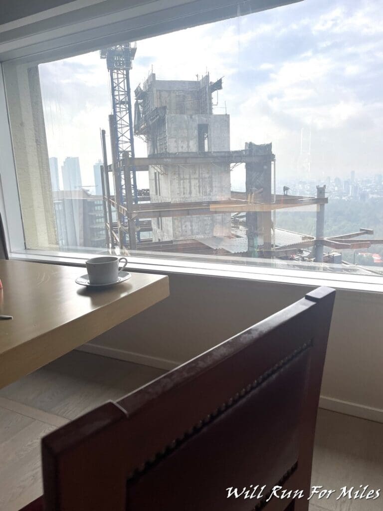 a table with a cup on it and a building under construction