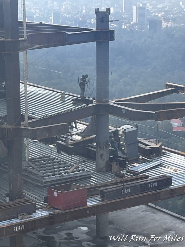 a construction site with a man on a metal structure