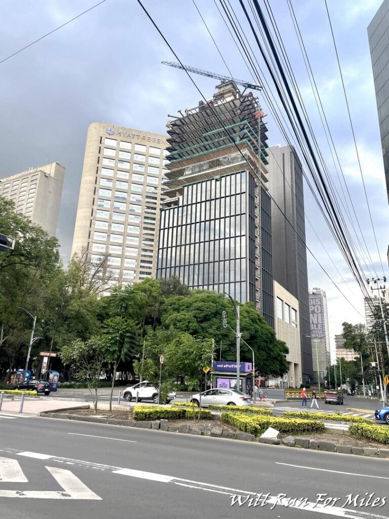 a city street with tall buildings and power lines