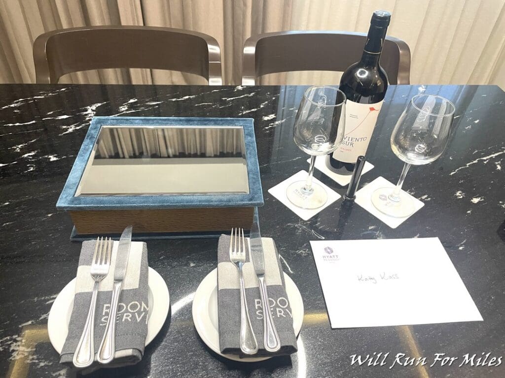 a table with wine glasses and silverware