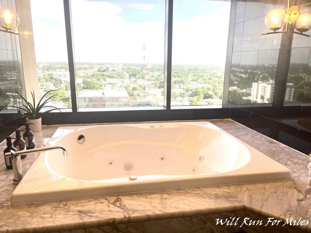a large white bathtub with a marble counter top