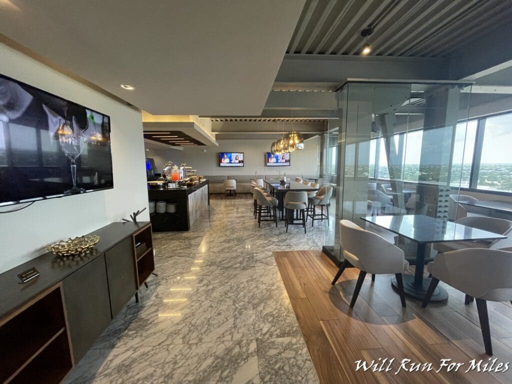 a room with a glass wall and a table and chairs