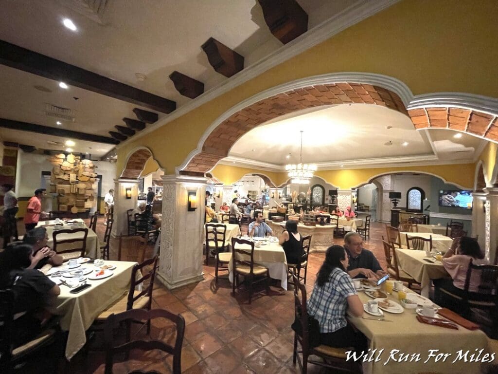 a group of people sitting at tables in a restaurant