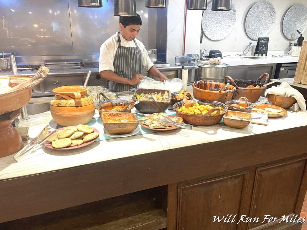 a man in a kitchen with many dishes