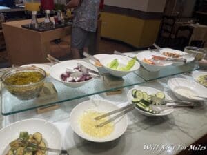 a buffet table with bowls of food