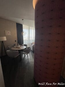 a room with a round table and chairs