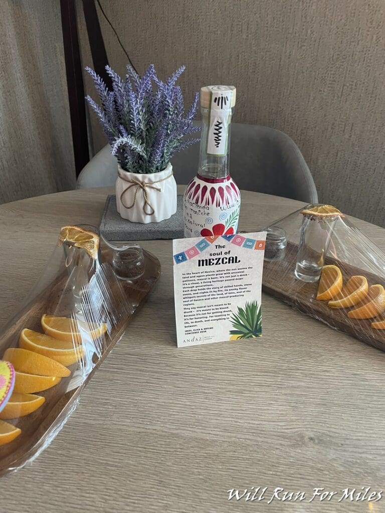 a table with a bottle of alcohol and orange slices on it