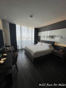 a room with a bed and a table and a television