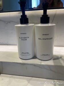 two white bottles with black lids