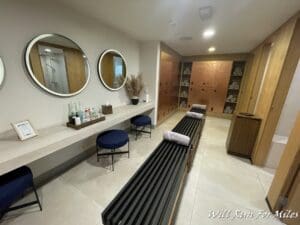 a room with a bench and mirrors