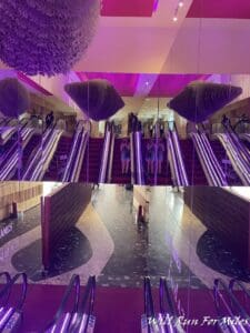 a group of people standing on escalators