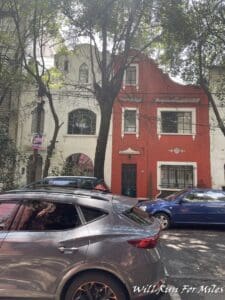 cars parked cars in front of a red building