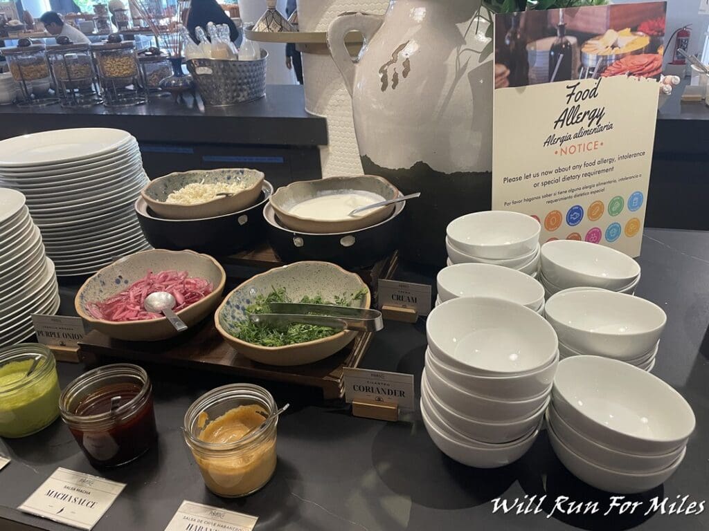 a table with bowls and bowls of food