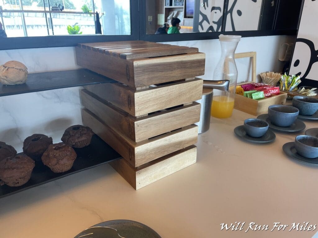 a wooden box with a stack of muffins on a counter