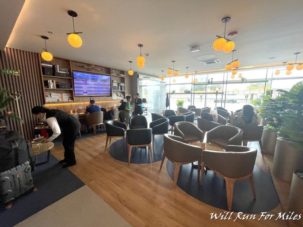 a room with a group of people and tables