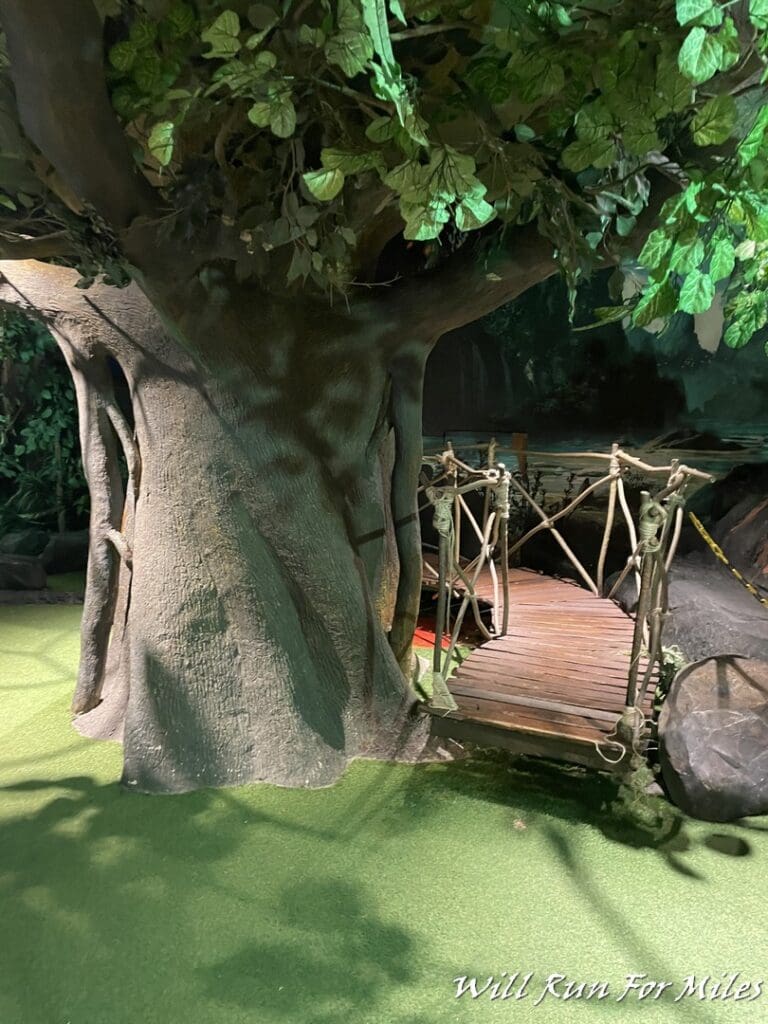 a wooden bridge under a tree