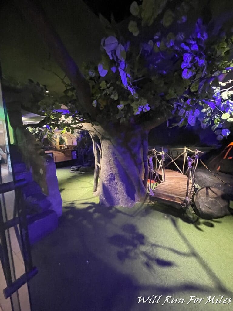 a tree with a bridge and a wooden bridge